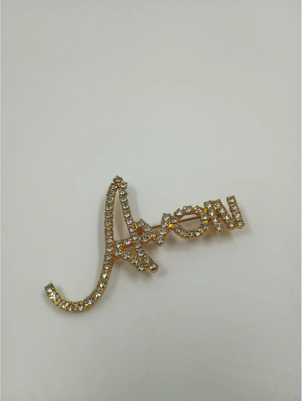 Avon Gold Tone Rhinestone Script Brooch Pin